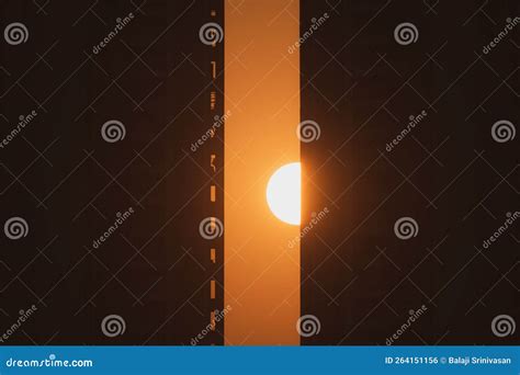 Sun Setting Behind A High Rise Skyscraper Stock Photo Image Of