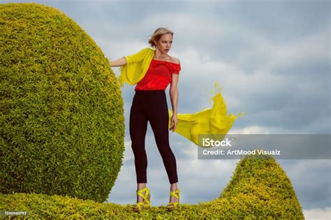Beautiful Young Blonde Woman Dressed In Primary Colors Standing On A