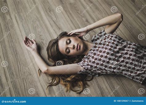 The Girl Lay On The Parquet Floor Arms Outstretched 6962 Stock Image