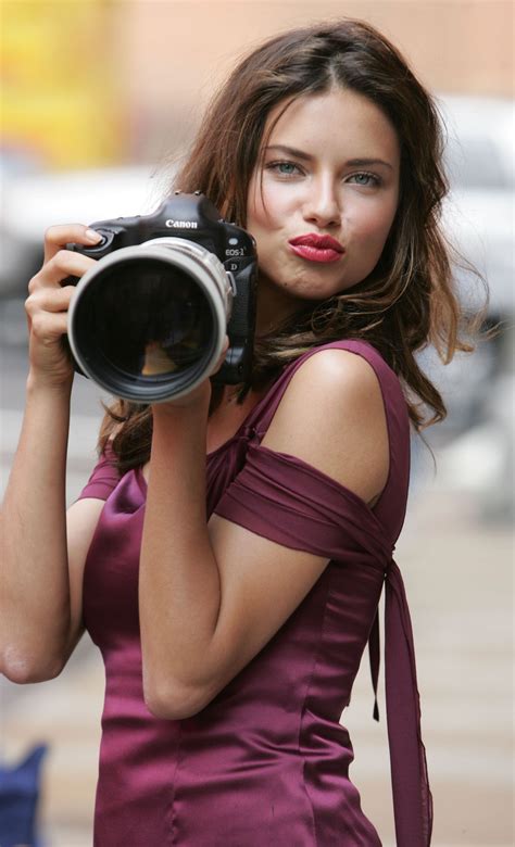 A Woman With Purple Lipstick Holding A Camera