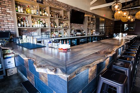 It consists of two decommissioned steel oil barrels stacked on top of one other. Okra Cookhouse & Cocktails Live Edge Bar Top | Porter Barn ...