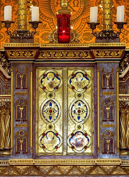 An Ornate Gold And Red Cabinet With Candles