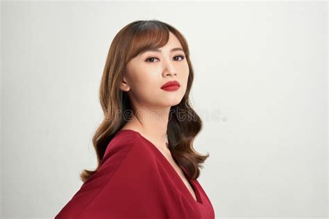 asian woman in satin dress with red lips touching neck isolated on white stock image image of