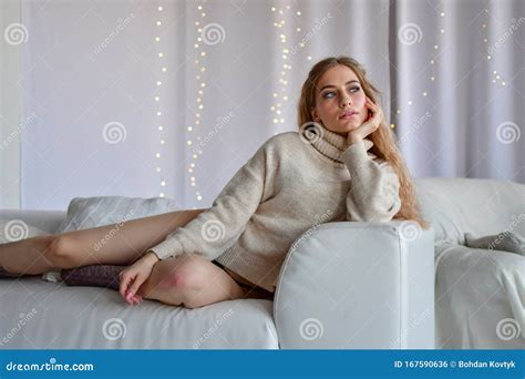 Girl Lying On Sofa In Sweaters And Socks And In Black Underwear Stock