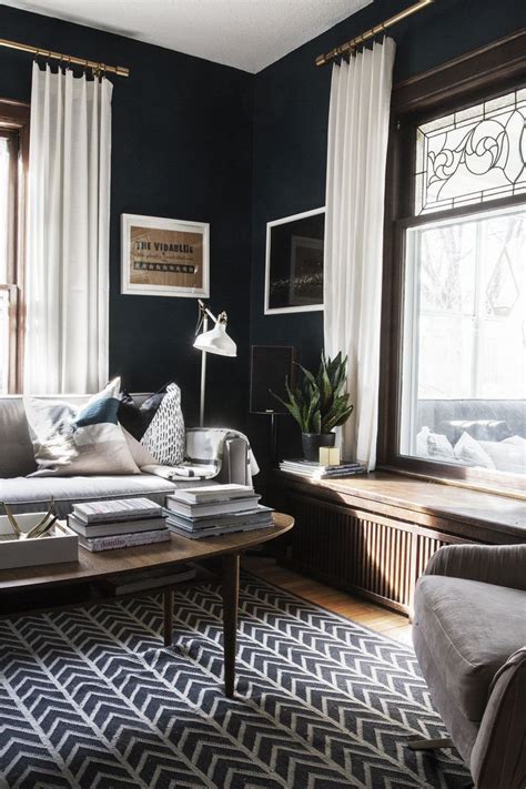 Walls clad in dark, rich wood paneling provide an elegant look in this living room. House Tour - Deuce Cities Henhouse | Dark walls living ...