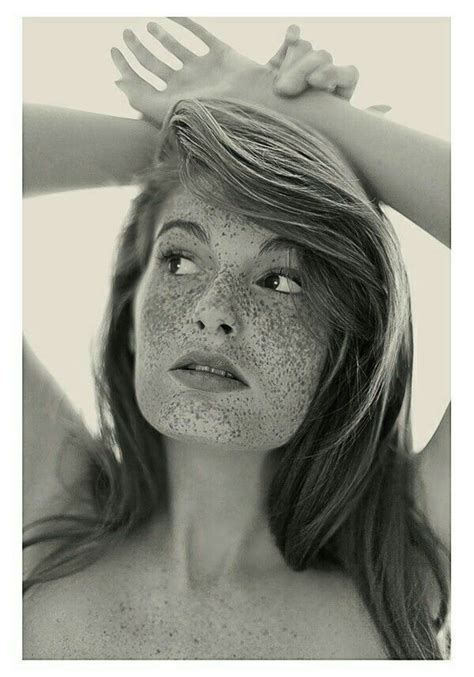 A Black And White Photo Of A Woman With Freckles On Her Face