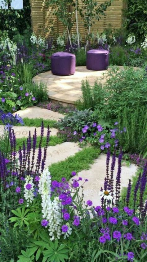 An Outdoor Garden With Purple And White Flowers