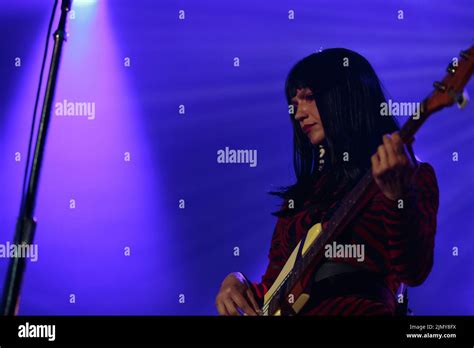 Bassist Laura Lee Of Khruangbin On Stage Wearing A Red Jumpsuit Stock