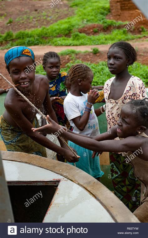 Mali Africa Black Young Girls Having Fun Working And Playing On A Rudimentary Well In A