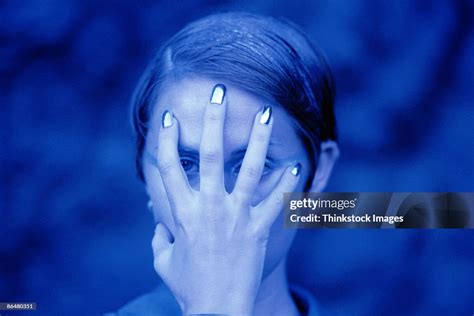 Woman Holding Hand Over Face High Res Stock Photo Getty Images