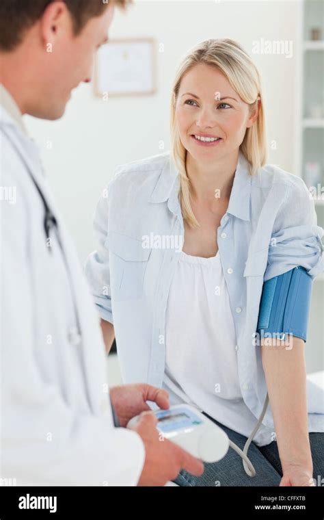 Smiling Woman Getting Her Blood Pressure Measured Stock Photo Alamy