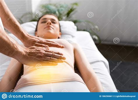 View Of Healer Standing Near Woman And Holding Hands Above Her Stomach