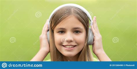 Portrait Of School Girl With Smiling Face Listening To Music In