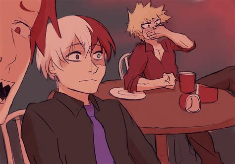 Two People Are Sitting At A Table With Drinks And One Is Holding His