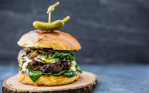 Gourmet burger with spinach, fried scallions, ginger-flavored yogurt ...