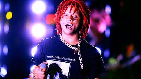 Red Braided Hair Trippie Redd Is Standing In Colorful Lights Background