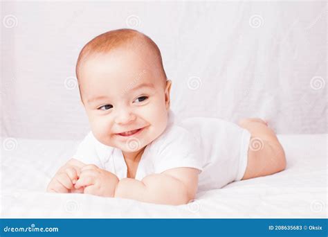 Happy Baby Lying On White Bed And Smile Stock Image Image Of