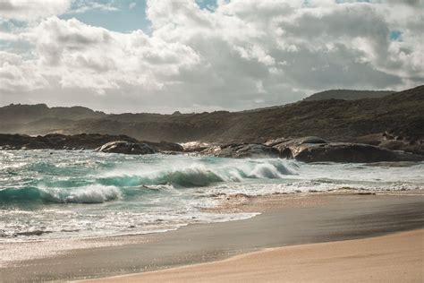 Stormy Sea Waving Rough Cliffs And Sandy Beach · Free Stock Photo