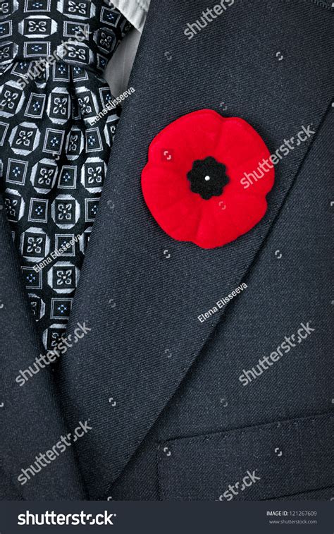 Red Poppy Lapel Pin On Suit Jacket For Remembrance Day