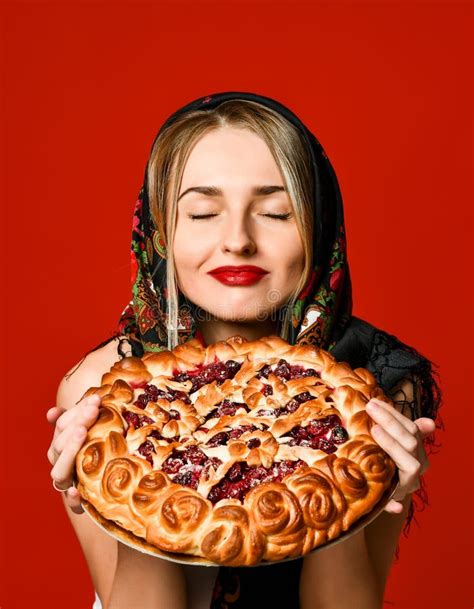 Portrait Of A Young Beautiful Blonde In Headscarf Holding A Delicious Homemade Berry Pie Stock