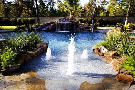Playful Bubblers On A Tropical Beach Entry Pool With Grotto Waterfall