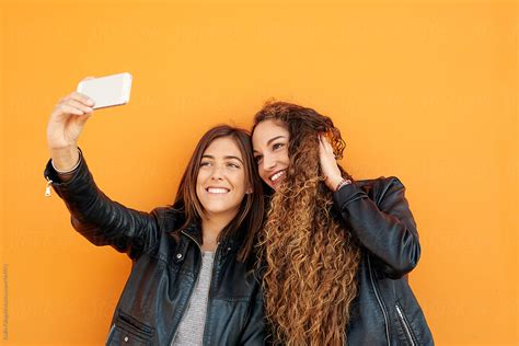 Two Attractive Girlfriends Taking Selfie By Stocksy Contributor Guille Faingold Stocksy
