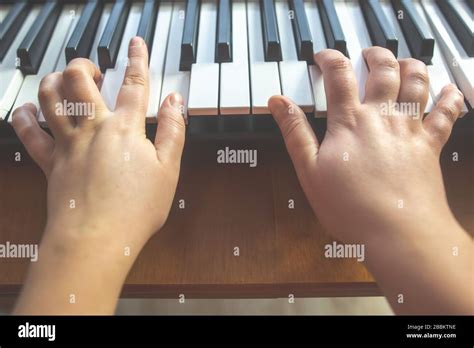 Close Up Of Young Woman Hands Playing On The Piano Instrument Stock