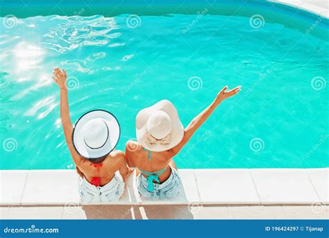 Two Girls Sitting By The Pool Relaxing Having Fun Stock Image Image