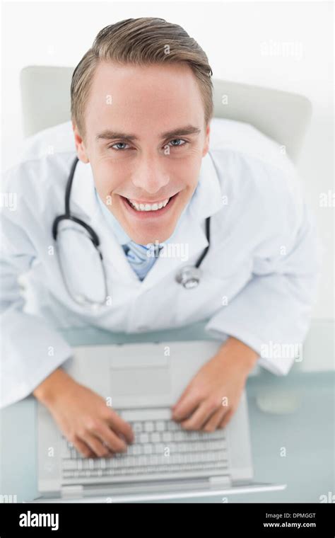 Overhead Portrait Of A Smiling Male Doctor Using Laptop Stock Photo Alamy
