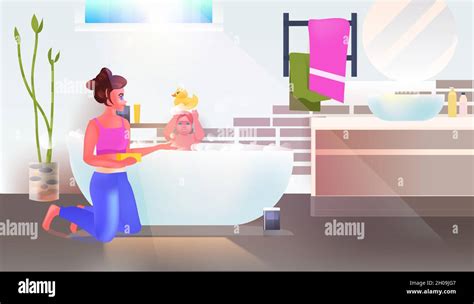 Young Woman Washing Little Daughter In Bath Bathroom Interior Horizontal Full Length Stock