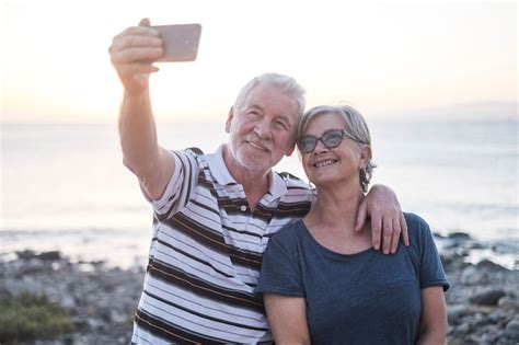 Premium Photo Couple Of Seniors At The Beach Taking A Photo Together