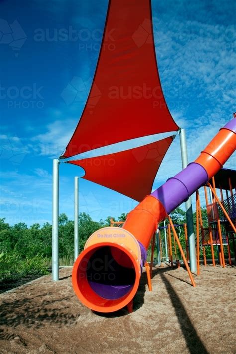 Image Of Tunnel Slide With Red Shade Sail At Playground Austockphoto