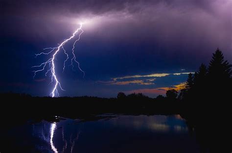 Lightning Storm Over A Lake Photograph By Corey Hochachka