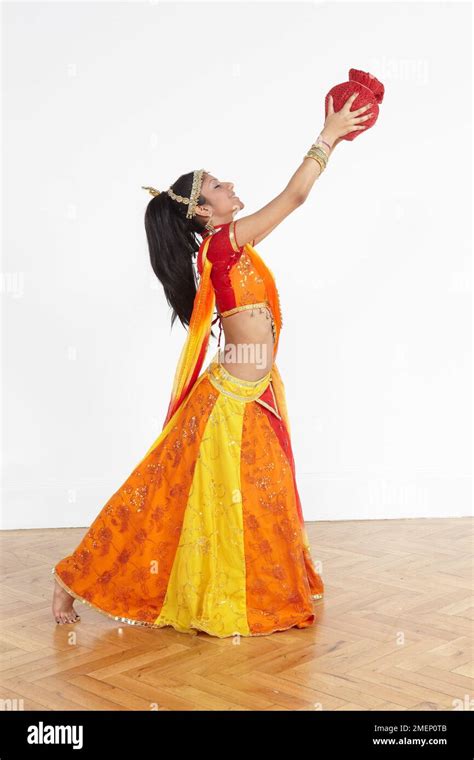 Barefoot Female Dancer In A Brightly Coloured Traditional Dress