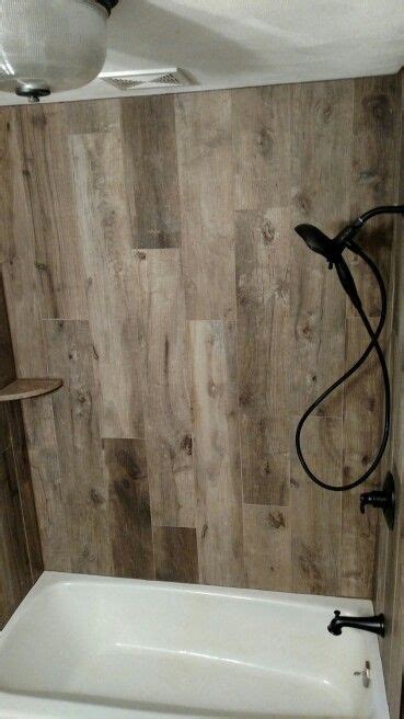 From built in cabinet surrounding bathtub or nook by the tub to shower niche around corner or floating shelves above bathtub, each idea is inexpensive and easy to do, making your small bathroom so large. Wood tile tub surround … | Tile tub surround, Bathroom ...