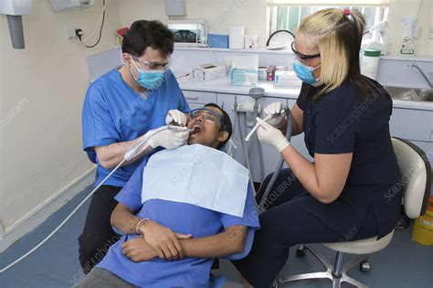 Dentist And Dental Nurse Carrying Out Dental Treatment Stock Image