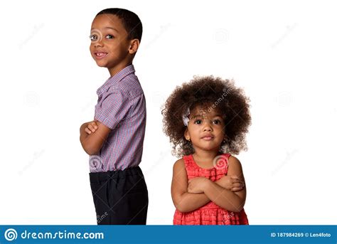 Two Smiling African American Siblings Standing Back To Back With Arms