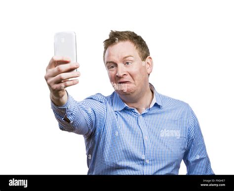 Man Making Funny Faces While Taking Selfie Of Himself Studio Shot On