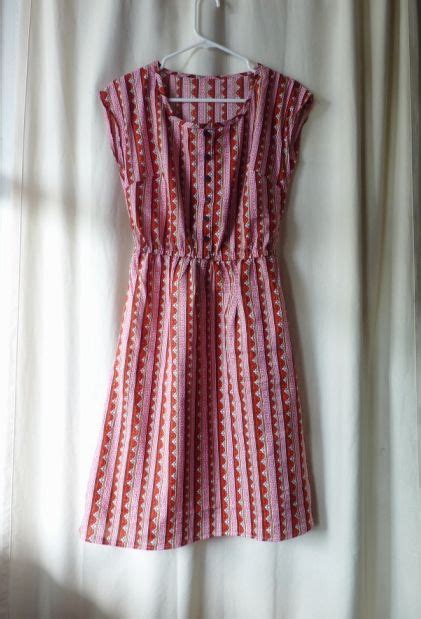 A Red And White Dress Hanging On A Hanger