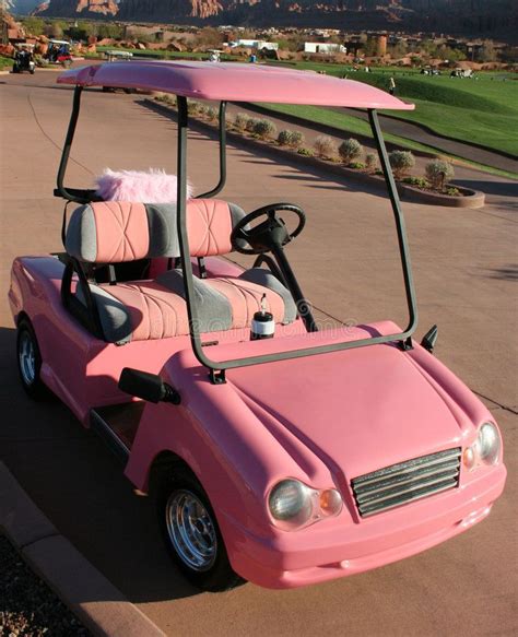 A Pink Golf Cart Is Parked In The Driveway