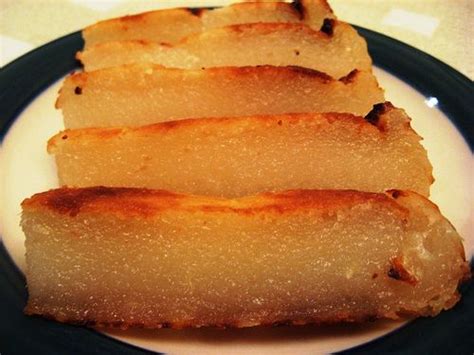 This cassava cake is coated with shredded coconut. Bánh Khoai Mì (Vietnamese Cassava Coconut Cake) | Vietnamese dessert, Asian desserts, Vietnamese ...
