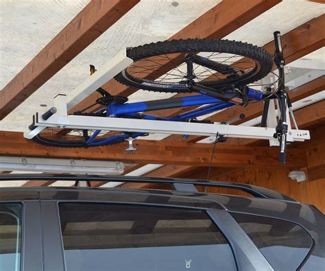 Raise and lower a 50 lb bike up to 12' by simply latching the hooks to the seat i dicided to install a ceiling mount bike lift for storing our bikes and free up some precious garage space. Ceiling Bike Lift for Garages, Hallways, Basements | flat-bike-lift