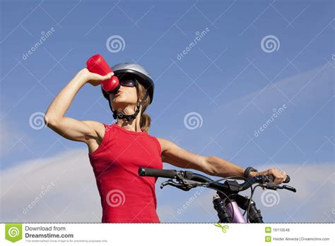 Woman Drinking Water In Her Bike Royalty Free Stock Photos