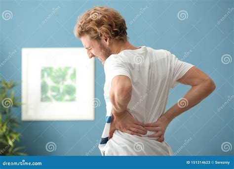 Young Man Suffering From Back Pain At Home Stock Image Image Of Hurt