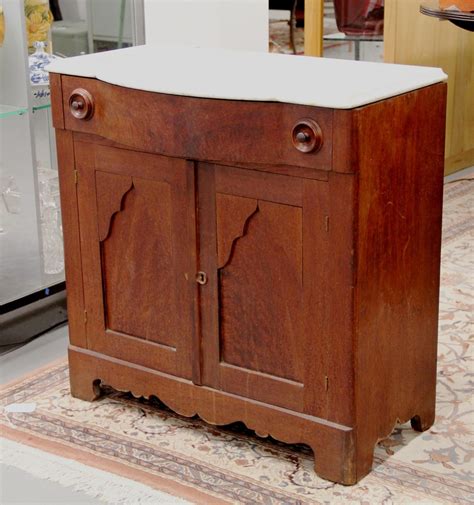 A laminated gray marble top enhances the lustrous look of this traditional warm brown finish bar unit. FOUND in ITHACA » FOUND Objects 7/29/2012