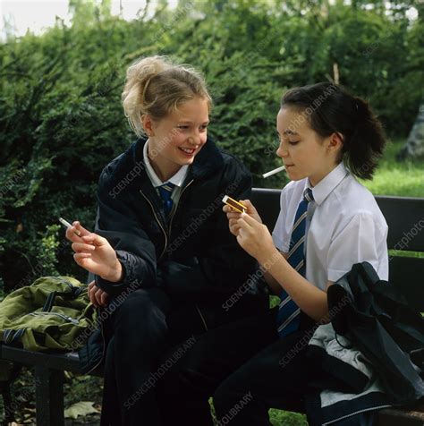 Young Teenage Girls Lighting Cigarettes Outdoors Stock Image M370