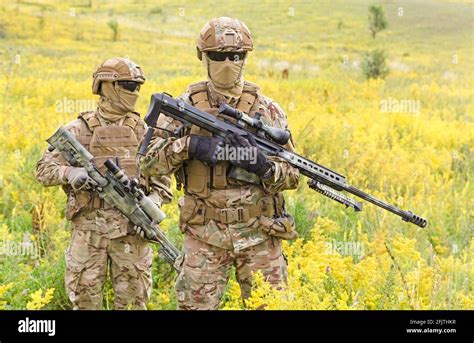 Two Armed Special Forces Soldiers With Sniper Rifles Standing In The
