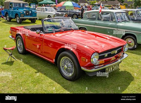 Side View Of A Vintage Triumph Tr6 Sports Car In Brilliant Red On