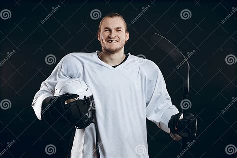 Handsome Hockey Player Smiling At Camera Isolated On Black Background