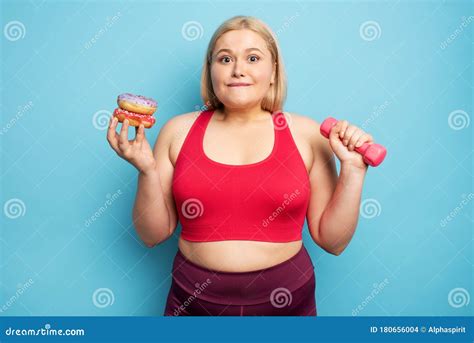 Fat Girl Thinks To Eat Donuts Instead Of Does Gym Concept Of Indecision And Doubt Stock Photo